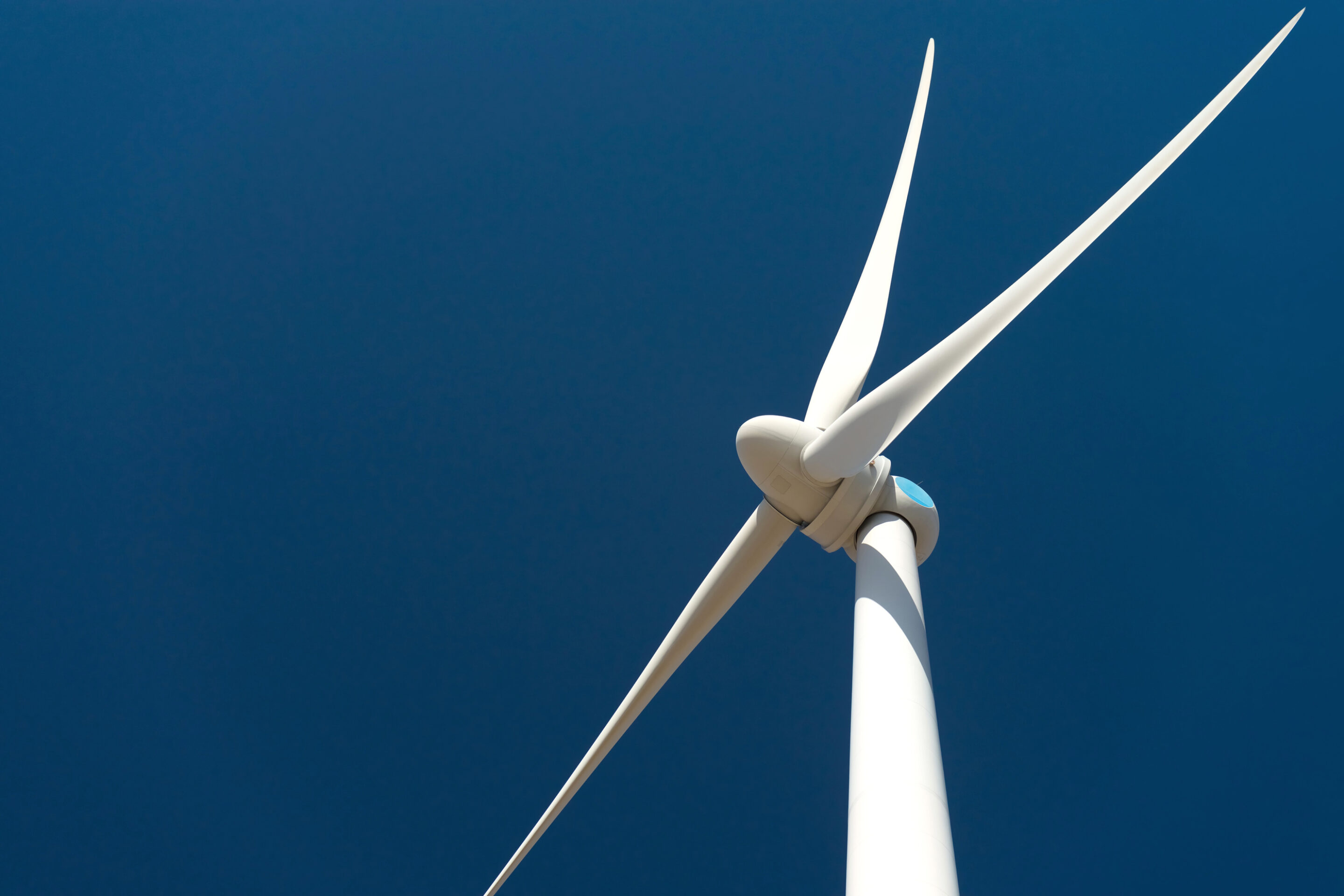Wind turbine against deep blue sky